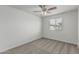 Bedroom with neutral carpet, ceiling fan, and window at 923 E Agua Fria Ln, Avondale, AZ 85323