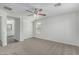 Large bedroom features a window with blinds, carpet flooring, and a ceiling fan at 923 E Agua Fria Ln, Avondale, AZ 85323