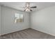 Bedroom with carpet floors, ceiling fan, and window at 923 E Agua Fria Ln, Avondale, AZ 85323