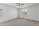 This bedroom includes a ceiling fan and a window with blinds at 923 E Agua Fria Ln, Avondale, AZ 85323