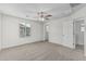 This bedroom features a ceiling fan, carpet flooring, and a window at 923 E Agua Fria Ln, Avondale, AZ 85323