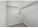Walk-in closet with carpet floors and ample shelving at 923 E Agua Fria Ln, Avondale, AZ 85323