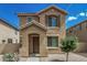 Charming two-story home featuring a covered entryway and well-maintained desert landscaping at 923 E Agua Fria Ln, Avondale, AZ 85323