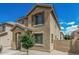 Charming two-story home featuring a covered entryway and well-maintained desert landscaping at 923 E Agua Fria Ln, Avondale, AZ 85323