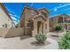 Charming two-story home featuring a covered entryway and well-maintained desert landscaping at 923 E Agua Fria Ln, Avondale, AZ 85323