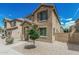Charming two-story home featuring a covered entryway and well-maintained desert landscaping at 923 E Agua Fria Ln, Avondale, AZ 85323