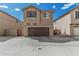 Exterior front elevation of the home with attached garage and desert landscaping at 923 E Agua Fria Ln, Avondale, AZ 85323