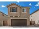 Exterior front elevation of the home with attached garage and desert landscaping at 923 E Agua Fria Ln, Avondale, AZ 85323