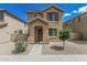 Charming two-story home featuring a covered entryway and well-maintained desert landscaping at 923 E Agua Fria Ln, Avondale, AZ 85323