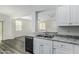 This kitchen offers granite countertops, stainless steel sink, and a black dishwasher at 923 E Agua Fria Ln, Avondale, AZ 85323