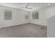 Bright living room with plush carpet, neutral paint, and natural light from multiple windows at 923 E Agua Fria Ln, Avondale, AZ 85323