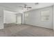 Bright living room with plush carpet, neutral paint, and natural light from multiple windows at 923 E Agua Fria Ln, Avondale, AZ 85323