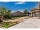 Large backyard featuring block wall, covered patio, and drought-tolerant landscaping at 9325 W Elwood St, Tolleson, AZ 85353