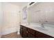 Bathroom featuring a dual sink vanity with a large mirror and a combined shower and bathtub at 9325 W Elwood St, Tolleson, AZ 85353