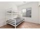 Bedroom featuring a white bunk bed next to a window with blinds at 9325 W Elwood St, Tolleson, AZ 85353