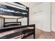 Bedroom featuring a black bunk bed and a white closet with sliding doors at 9325 W Elwood St, Tolleson, AZ 85353