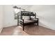 Sunlit bedroom showcasing a dark-wood bunk bed next to a window at 9325 W Elwood St, Tolleson, AZ 85353