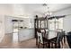 Bright dining area with a wooden table, elegant china cabinet, and views of the outdoor space at 9325 W Elwood St, Tolleson, AZ 85353