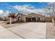 Charming single-story home showcasing a neutral color palette, a spacious driveway, and a two-car garage at 9325 W Elwood St, Tolleson, AZ 85353