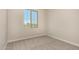 Carpeted bedroom with a window showcasing the neighborhood view at 9408 E Sequence Ave, Mesa, AZ 85212