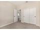 Bedroom with carpet, featuring closet doors and access to other rooms at 9408 E Sequence Ave, Mesa, AZ 85212