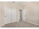 Bedroom with neutral tones featuring large closet doors, providing ample storage space at 9408 E Sequence Ave, Mesa, AZ 85212