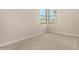 Carpeted bedroom features a large window for natural light at 9408 E Sequence Ave, Mesa, AZ 85212