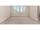 Carpeted bedroom features a dual window and base trim at 9408 E Sequence Ave, Mesa, AZ 85212