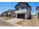 Street view of stucco homes with grey siding, dark garage doors, desert landscaping, and well-maintained lawns at 9408 E Sequence Ave, Mesa, AZ 85212