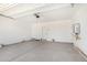 Spacious two-car garage with automatic door and water heater; blank canvas for storage or hobbies at 9408 E Sequence Ave, Mesa, AZ 85212
