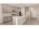 Stylish kitchen featuring gray cabinets, quartz countertops, a center island with sink, and stainless steel appliances at 9408 E Sequence Ave, Mesa, AZ 85212