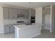 Modern kitchen featuring stainless appliances, light grey cabinetry, and quartz countertops at 9408 E Sequence Ave, Mesa, AZ 85212