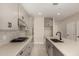 Modern kitchen featuring gray cabinets, quartz countertops, a center island with sink, and stainless steel appliances at 9408 E Sequence Ave, Mesa, AZ 85212