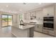 Spacious kitchen featuring gray cabinets, quartz countertops, a center island with sink, and stainless steel appliances at 9408 E Sequence Ave, Mesa, AZ 85212