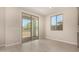 Bright living room featuring sliding glass doors, a window, neutral walls, tile floors, and access to the outdoors at 9408 E Sequence Ave, Mesa, AZ 85212