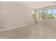 Bright, spacious living room with wood-look tile floors and many windows at 9408 E Sequence Ave, Mesa, AZ 85212