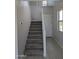 Carpeted staircase featuring white banister and light wood-style flooring in entrance hall at 9408 E Sequence Ave, Mesa, AZ 85212