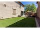 Backyard with artificial turf, brick paved patio, string lights, and ample space for outdoor activities at 9412 S 34Th Dr, Laveen, AZ 85339