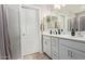 A bright bathroom featuring dual sinks, a white vanity and a tile floor at 9412 S 34Th Dr, Laveen, AZ 85339