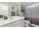 Bathroom featuring a vanity with white countertop, framed mirror, and stylish gray shower curtain at 9412 S 34Th Dr, Laveen, AZ 85339