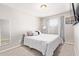 A well-lit bedroom with neutral walls and carpet, with a full size bed and ample natural light at 9412 S 34Th Dr, Laveen, AZ 85339