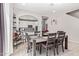 A dining room featuring a wooden table, a bar cart and an open view to the kitchen at 9412 S 34Th Dr, Laveen, AZ 85339