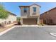 Two-story home featuring a neutral color scheme, attached garage, and well-maintained landscaping at 9412 S 34Th Dr, Laveen, AZ 85339