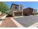 Exterior shot of a two-story home with desert landscaping, two-car garage, and neutral color scheme at 9412 S 34Th Dr, Laveen, AZ 85339