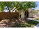 Attractive single-story home with desert landscaping, arched porch, and mature trees in a sunny setting at 9412 S 34Th Dr, Laveen, AZ 85339