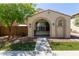 Charming single-story home with an arched porch, desert landscaping, and a welcoming entrance at 9412 S 34Th Dr, Laveen, AZ 85339