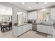 Bright kitchen boasts white cabinets, stainless steel appliances, and an adjacent dining area at 9412 S 34Th Dr, Laveen, AZ 85339