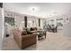 Comfortable living room showcasing a large sectional sofa, tile flooring, and abundant natural light at 9412 S 34Th Dr, Laveen, AZ 85339