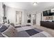 A comfortable main bedroom showcasing a large bed, neutral decor, and multiple doorways at 9412 S 34Th Dr, Laveen, AZ 85339