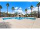 Community pool with a clear blue water and tall palm trees at 9412 S 34Th Dr, Laveen, AZ 85339